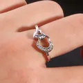 Elegant silver interlocking double heart ring with sparkling zircons on finger - US 7 / Silver