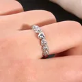 Macro shot of silver heart ring featuring polished metal and micro-pave cubic zirconia - US 7 / Silver