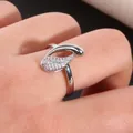 Infinity drop cubic zirconia copper ring with asymmetric streamlined leaf design on hand - Size 7 / Silver