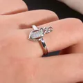 Macro detail of oval flower ring with micro-pave cubic zirconia and hollow floral motifs - US 7 / Silver
