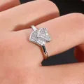 Macro detail of double heart silver ring with pavé micro-set cubic zirconia on hand - US 7 / Silver