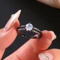 Macro shot of double layer black metal ring with split shank and sparkling zircon stones - US 7 / Black