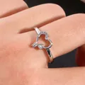 Macro shot of silver-plated double heart ring featuring cubic zirconia stones on hand - US 7 / Silver
