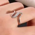 Macro shot of silver-tone wavy geometric ring with micro-pave cubic zirconia inlay - US 7 / Silver