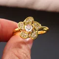 Elegant gold five-petal flower ring with micro-paved cubic zirconia on finger - US 7 / Gold