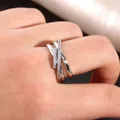 Macro view of a silver crisscross layered ring set with micro-pave white cubic zirconia - US 7 / Silver