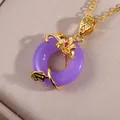 Macro shot of purple gemstone pendant with gold floral vine filigree and zircon details - Dark Purple