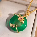 Macro shot of green jadeite donut necklace with golden flower and red gemstone detail - Transparent Green