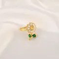 Detail view of sunflower ring featuring yellow gemstone and green leaf accents - Floral Open Ring (R1302)
