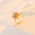 Bague rotative dorée avec motif fleur en zircon rose sur un socle minimaliste - Rose (J0080)