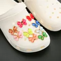 Set of 9 colorful acrylic butterfly shoe charms shown on a white clog shoe - Mixed Color Rhinestone Butterfly Alloy Accessories