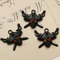 Macro shot of pirate skull charms with red rhinestone eyes and black enamel finish - Black Red Eye Pirate Skull Style