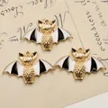 Detailed view of three bat charms with gold metal edges and black and white enamel finish - Gold Bat Style