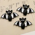 Detailed macro view of black and white bat charms for Halloween DIY jewelry making - Black Bat Style