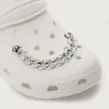 Cadena de metal plateado con pedrería blanca para decorar zuecos sobre zapato blanco - Cadena Plateada Con Diamantes
