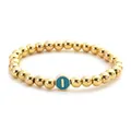 Detailed close-up of golden beaded bracelet featuring a teal enamel letter I charm - Letter I Style
