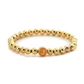 Close-up of golden beaded stretch bracelet featuring a custom letter J round pendant - Letter J Style