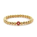 Macro detail of alloy beaded bracelet with golden beads and a red letter K pendant - Letter K Style