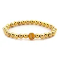 Close-up of golden beaded stretch bracelet featuring a yellow enamel round letter L charm - Letter L Style