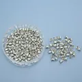Silver bullet clutch earring backs in a round plastic storage box for DIY jewelry - Silver