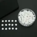 Bulk set of clear silicone butterfly earring backs in round storage box on black background - White Nipple Style Earring Backs