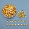 Golden flower-shaped alloy bead caps in a transparent storage box for jewelry DIY - Gold