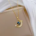Gold celestial necklace featuring a zircon moon and blue planet pendant on silk fabric - Crescent Planet Style (264)