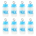 Close-up of eight cute resin milk bottle charms with blue accents and silver metal rings - Blue