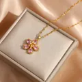 Pink five-petal flower necklace with gold chain displayed on a luxury jewelry box - Pink