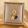 Golden graduation necklace with heart, passport and blue cap pendants on silk backdrop - Graduation Travel Theme Heart Passport Graduation Cap(XL3509)