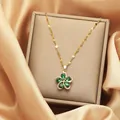 Detailed macro view of golden flower necklace with green stones on silk lining - Green