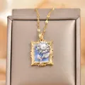 Vintage gold frame necklace with blue enamel sunflower and pearl pendant on a beige box - Blue Sunflower Picture Frame Style (XL3632)