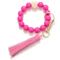 Detail of rose red wooden bead keychain bracelet with leather tassel and gold metal ring - Rose Red