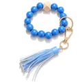 Detail of blue wooden bead bracelet keychain with leather tassel and gold ring clasp - Blue