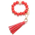 Close-up of red beaded wristlet keychain with wooden hexagonal bead and leather tassel - Red