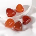 Detailed view of five polished red agate gemstones on white silk fabric background - Agate Raw Stone