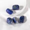 Close-up of polished natural Lapis Lazuli stones on a minimalist white display stand - Lapis Lazuli Raw Stone