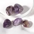 Close-up of five polished natural amethyst stones with unique textures on silk background - Amethyst Raw Stone