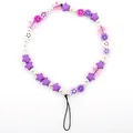 Detailed macro view of colorful smiley face beads and purple stars on the phone lanyard - Purple