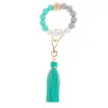 Detail of beaded keychain bracelet with silicone beads, wooden eye bead, and tassel - Lake Blue