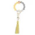 Detail of beaded wristlet keychain with silicone beads, wood bead, and yellow tassel - Yellow