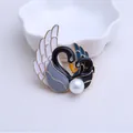 Elegant gold swan brooch with white enamel detail and pearl in heart shape design - Blue