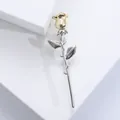 Elegant rose brooch in gold and silver finish on minimalist white background - Gold