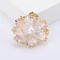 Elegant gold peony flower brooch with pearlescent petals and a large center pearl - White