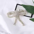 Spilla a fiocco in argento con strass scintillanti e nappa per abbigliamento elegante - Oro
