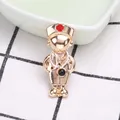 Close-up of golden alloy doctor brooch with enamel stethoscope and red cross detail - Gold