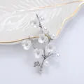 Elegant silver flower brooch featuring white pearls and enamel blossom branch for suits - Silver