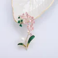 Elegant orchid flower brooch with pink gemstones, green enamel leaves, and a large pearl - Pink