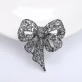 Elegant vintage bow brooch in antique silver finish with sparkling grey rhinestones - Silver