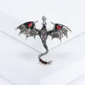 Macro detail of silver dragon brooch with black enamel wings and red crystals - Gray